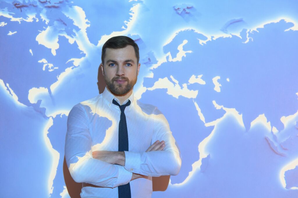 International business concept with businessman on background with network on map.